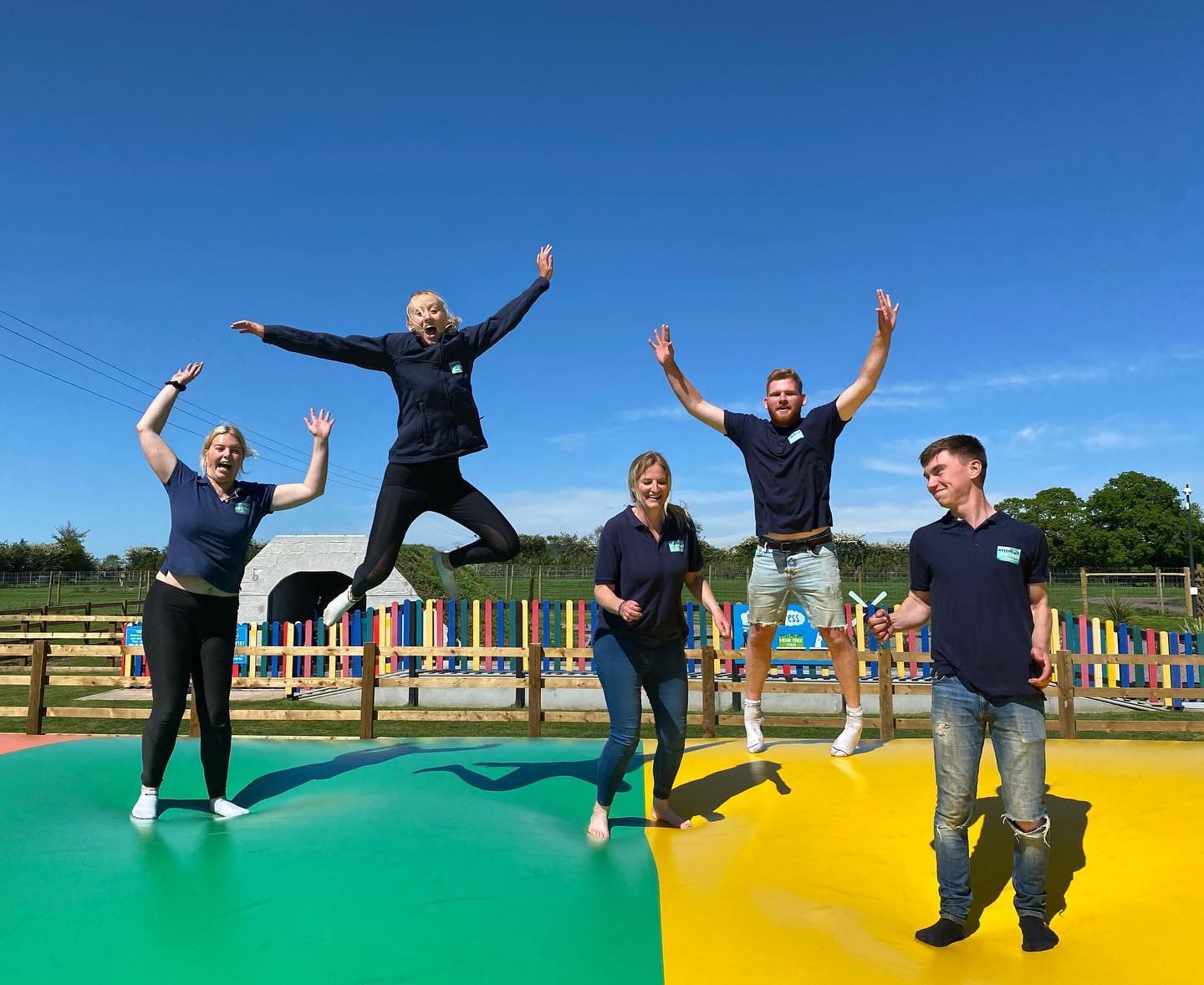 People jumping on giant bouncing pillows