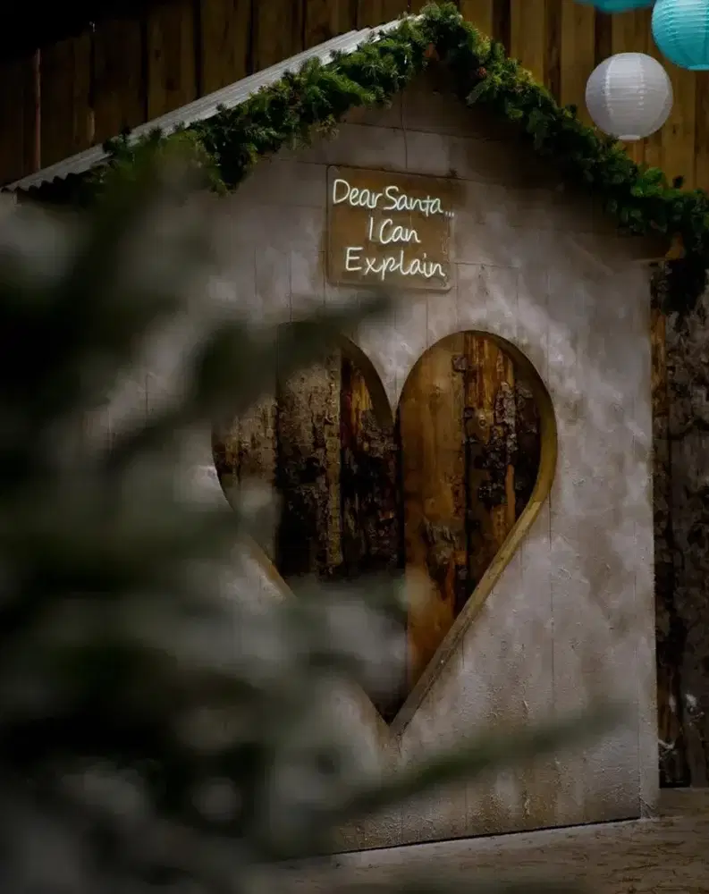 Snowy hut with heart window and Dear Santa I Can Explain sign
